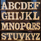 Lumina Lights Full A-Z Alphabet Marquee LED Letter Set with warm white glowing bulbs displayed on wooden shelves — 26 letters complete set for wedding and party decoration